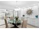 Elegant dining room with glass table and chandelier at 2322 Riverbluff Pkwy # V250, Sarasota, FL 34231