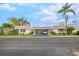 Single-story condo with carport, landscaped yard, and palm trees at 2322 Riverbluff Pkwy # V250, Sarasota, FL 34231