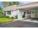 Tan and white exterior with carport and landscaping at 2322 Riverbluff Pkwy # V250, Sarasota, FL 34231