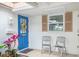 Inviting front entry with blue door and two chairs at 2322 Riverbluff Pkwy # V250, Sarasota, FL 34231