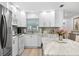 Modern kitchen with white cabinets and a large island at 2322 Riverbluff Pkwy # V250, Sarasota, FL 34231