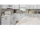 White kitchen with marble countertops and stainless steel appliances at 2322 Riverbluff Pkwy # V250, Sarasota, FL 34231
