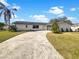 Newly renovated home with modern exterior and a spacious front yard at 4706 Onyx Pl, Tampa, FL 33615