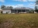 Large backyard with screened enclosure and grassy area at 13 Perimeter Dr, Englewood, FL 34223