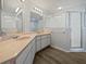 Bathroom with double vanity and a shower stall at 13 Perimeter Dr, Englewood, FL 34223