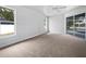 Bright bedroom with carpet floors and patio access at 13 Perimeter Dr, Englewood, FL 34223