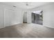 Bedroom with carpet flooring and access to the patio at 13 Perimeter Dr, Englewood, FL 34223