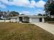 Single-story home with attached garage and well-maintained lawn at 13 Perimeter Dr, Englewood, FL 34223