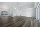 Open living room with wood-look floors and high ceilings at 13 Perimeter Dr, Englewood, FL 34223