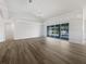 Spacious living room with a view of the pool and sliding glass doors at 13 Perimeter Dr, Englewood, FL 34223