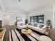 Bright living room featuring comfy seating and a view of the pool at 13 Perimeter Dr, Englewood, FL 34223
