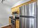 Modern kitchen featuring stainless steel appliances and wood cabinets at 2400 Feather Sound Dr # 613, Clearwater, FL 33762