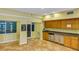 Community kitchen with wood cabinets and granite countertops at 2400 Feather Sound Dr # 613, Clearwater, FL 33762