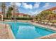 Community pool with lounge chairs and a brick patio at 2400 Feather Sound Dr # 613, Clearwater, FL 33762