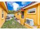 Small backyard with AC units and side access at 2600 N Paula Dr # 19A, Dunedin, FL 34698