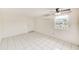 Bright bedroom with tile floor and ceiling fan at 2600 N Paula Dr # 19A, Dunedin, FL 34698