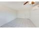 Simple bedroom with tile floors and ceiling fan at 2600 N Paula Dr # 19A, Dunedin, FL 34698