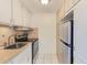 Galley kitchen with stainless steel appliances at 2600 N Paula Dr # 19A, Dunedin, FL 34698