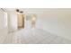 Bright living room with tile floors and kitchen access at 2600 N Paula Dr # 19A, Dunedin, FL 34698