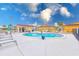 Inviting pool area with lounge chairs and a patio; perfect for relaxation at 2600 N Paula Dr # 19A, Dunedin, FL 34698