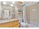Bathroom with tub, granite vanity and wood cabinets at 11511 113Th St # 13F, Seminole, FL 33778