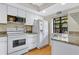 Well-equipped kitchen with white cabinets, granite counters, and stainless steel appliances at 11511 113Th St # 13F, Seminole, FL 33778