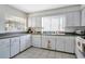 Well-equipped kitchen featuring white cabinets and dark countertops at 11511 113Th St # 13F, Seminole, FL 33778