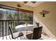 Screened lanai with table and chairs, overlooking nature at 11511 113Th St # 13F, Seminole, FL 33778