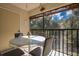 Enjoy a relaxing screened balcony with table and chairs, perfect for outdoor dining at 11511 113Th St # 13F, Seminole, FL 33778