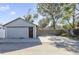 Gray detached garage with a wooden gate and driveway at 2011 Dartmouth N Ave, St Petersburg, FL 33713