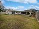 Large grassy backyard with a partially visible patio and shed at 2801 65Th N Way, St Petersburg, FL 33710