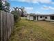 Large backyard with wooden fence and grassy area at 2801 65Th N Way, St Petersburg, FL 33710