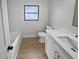 Clean and modern bathroom with white cabinets and marble-look wall tiles at 2801 65Th N Way, St Petersburg, FL 33710
