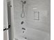 Updated bathroom with marble-look tile and a bathtub at 2801 65Th N Way, St Petersburg, FL 33710