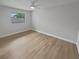 Simple and bright bedroom with light wood flooring and a large window at 2801 65Th N Way, St Petersburg, FL 33710