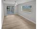 Bright bedroom with wood-look floors and sliding door to patio at 2801 65Th N Way, St Petersburg, FL 33710
