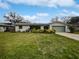Charming single story home with a well manicured lawn and green garage door at 2801 65Th N Way, St Petersburg, FL 33710