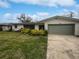 Ranch style home with a green garage door and well-maintained landscaping at 2801 65Th N Way, St Petersburg, FL 33710