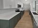 Modern kitchen with white and green cabinets, quartz countertops and herringbone backsplash at 2801 65Th N Way, St Petersburg, FL 33710