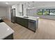 Modern kitchen featuring white and green cabinets, quartz countertops, and stainless steel appliances at 2801 65Th N Way, St Petersburg, FL 33710