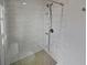 Updated shower with marble-look tile and a rain shower head at 2801 65Th N Way, St Petersburg, FL 33710