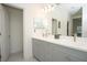 Modern bathroom with dual vanities and a large mirror at 3514 Shimmering Oaks Dr, Parrish, FL 34219