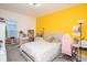 Bedroom with a queen-size bed and yellow accent wall at 3514 Shimmering Oaks Dr, Parrish, FL 34219