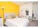 Bright bedroom with double bed, closet, and yellow accent wall at 3514 Shimmering Oaks Dr, Parrish, FL 34219