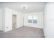 Bedroom with gray carpet, a window, and ensuite bathroom at 3514 Shimmering Oaks Dr, Parrish, FL 34219