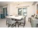 Modern dining room with large square table and chandelier at 3514 Shimmering Oaks Dr, Parrish, FL 34219
