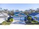 Two-story house with blue siding, two-car garage, and landscaping at 3514 Shimmering Oaks Dr, Parrish, FL 34219