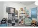 Organized home office with shelving unit and comfy armchair at 3514 Shimmering Oaks Dr, Parrish, FL 34219
