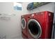 Laundry room with red LG washer and dryer at 3514 Shimmering Oaks Dr, Parrish, FL 34219