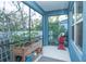 Screened porch with ample space for plants and seating at 3514 Shimmering Oaks Dr, Parrish, FL 34219
